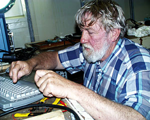 Tom Crook checks his computer programs that control the navigation system for Jason.  