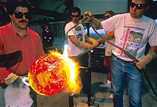 Glass artist Josh Simpson creates a Planet in his studio. Josh uses the blowtorch to incorporate some of the beautiful swirls and colors that give the Planets their special qualities.  