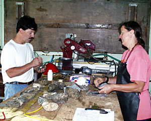 Captain AD Colburn and Geochemist Susan Humphris paint white labels on the rocks Susan collected in a dredge. She will later use the labels to categorize the rocks. 