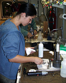 Graduate student Jenney Hall prepares sample bottles for use on the elevator. 