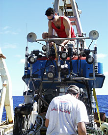 DSOG team member Fran Taylor makes adjustments on the top of ROV Jason while Chief Pilot Will Sellers checks things from below.  