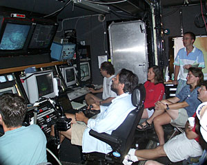 Hanging out in the control van proved popular today while we explored Knorr Seamount. In the center chair is Expedition Leader Andy Bowen, who is piloting Jason on the seafloor.  