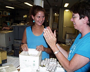 Graduate student Zoe McKiness and Microbial Biologist Colleen Cavanaugh pack samples in the main lab. 