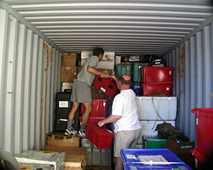 Geologist Dan Fornari and Biologist Tim Shank pile boxes into the shipping container, which will be shipped from Mauritius back to the United States and finally to Woods Hole Oceanographic Institution.  