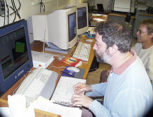  Alberto Saal stands watch at the multibeam sonar in the computer lab. The scientific party have been split into watches, each lasting 4 hours with 8 hours off in between for rest or other work. 