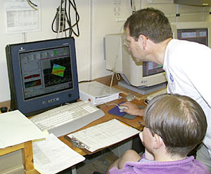  Just after lunch time the ship went over the "Galapagos Spreading Centre" (GSC). Here Rhian Waller and Mark Kurz look at the multibeam sonar as the ship travels over the GSC. Be sure to look at the maps of the Galapagos Spreading Center and the Galapagos Islands in today's slideshow.  