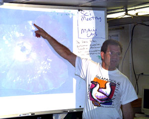 Mark Kurz gives a science presentation in the main lab about the geochemistry of the Galápagos hot spot. He is pointing to a LANDSAT image of Fernandina, the leading edge of the Galápagos hot spot. 