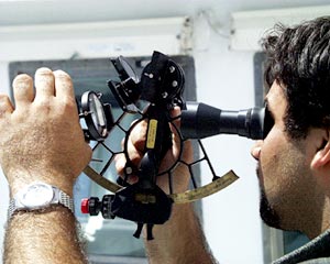  Joe Ferris, 3rd Mate, uses a sextant to determine the angle of the sun from the horizon. Calculating positions by celestial navigation helps the mates check the GPS navigation systems on the ship. 