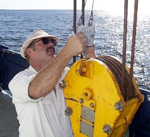 ”Big Al” Luallin, Marine Electrician, checks the block on the starboard crane.  