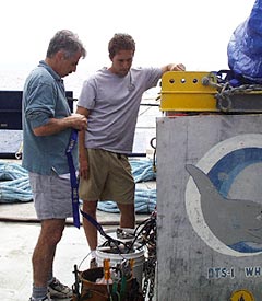 Dan Fornari and Todd Ericksen prepare the deep-sea digital camera for its deployment this evening.  