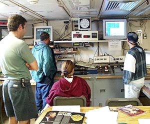 In the computer lab, the 8 to 12 watch monitors the dredge as it is sent to the sea floor. The pinger display and the wire tension are monitored closely during dredging operations.  