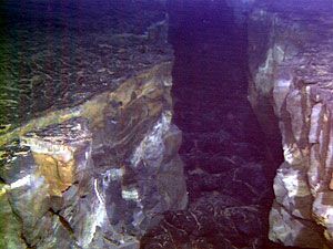  Photo of an underwater fissure taken during an Alvin dive on the East Pacific Rise. The darker lava at the bottom of the fissure is a new eruption. We believe this same type of process occurs here on the submarine rift zones of Fernandina and Cerro Azul volcanoes. 