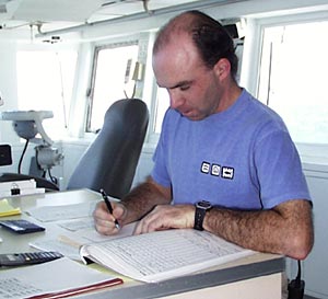  David Kirk, Second Mate, records our daily weather reports for the Dive and Discover web site. 