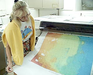  Uta Peckman collects one of the bathymetric maps from the printer in the main lab.  