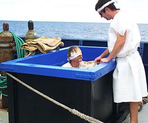 Polish Bowline (Bob Reynolds) is cleansed by a Noble Shellback (Josh Curtice) and emerges from the water and pronounces himself to be a Shellback. 