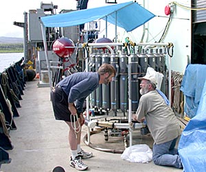 When new scientists arrive on board, they begin to set up their equipment. Kevin Roe (left) and Bob Collier (right) prepare water sampling bottles for the cruise. 