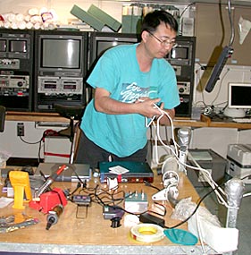 When new scientists arrive on board, they begin to set up their equipment. Kevin Roe (left) and Bob Collier (right) prepare water sampling bottles for the cruise. 