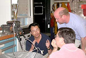 Kang Ding explains how the tip of the “Ghostbuster” sensor works to Co-Chief Scientists Steve Hammond and Tim Shank.
