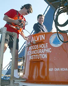 Alvin Pilot Blee Williams who is Launch Coordinator for Dive 3788, assists Co-Chief Scientist Steve Hammond into the submersible.