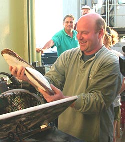  Co-Chief Scientist Tim Shank delightedly removes clams from Alvin’s basket after today’s dive.