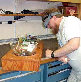  Al Duester repairs ABE’s transponder in one of Atlantis’ labs. “He’ll gripe about having to fix it, but he really loves it,” said Dana Yoerger with a smile. “He’s a nerd warrior going into battle, slaying dragons with his soldering gun.”