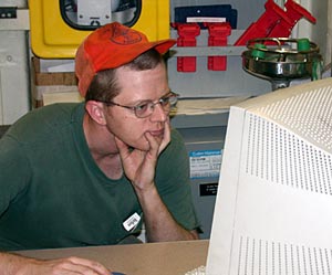  Second Engineer Jim Schubert updates the maintenance records in the Control Room of the Engine Room. 