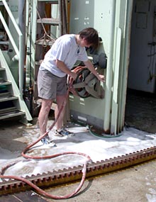Graduate student Rhian Waller gets up to her ankles in soap suds helping scrub out Alvin’s hangar.