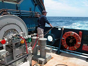 Scientist Dave Shuster watches the line that drags Maggie two boatlengths behind the ship. Maggie is the informal name for the device the science team uses to gain information about the area’s magnetic fields. 