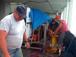 Bowsun Wayne Bailey and Ordinary Seaman Kevin Threadgold prepare the towed camera, or towcam, for future use.