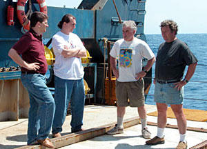 From left to right, Co-chief Scientist Dan Scheirer, Chief Scientist Jess Adkins, Ship Captain Gary Chiljean, and Alvin Expedition Leader Pat Hickey discuss whether conditions will allow a safe launch and retrieval. They set a make-up launch time for later that morning, but the swells remained too high and the launch was eventually postponed until the next day. 