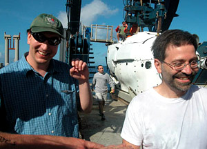 Scientist Diego Fernandez, right, celebrates his first Alvin dive with Chief Scientist Jess Adkins. Pilot Tony Tarantino is in the background.  