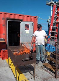 Bosun Wayne Bailey prepares for the ship cookout Sunday night. The cookout is eagerly anticipated throughout our journey as a time for the whole crew to relax together, enjoying fantastic fresh-grilled food in the open air. 