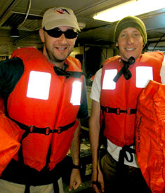 Monday means safety drill day. Here scientists Dave Shuster, left, and Alex Gagnon mug for the camera while mustering in the main lab. To muster means to gather and await instructions. When the alarm rings, everyone on board dons a flotation device and their personal immersion suit, and musters in a previously designated location. Roll is called, and then you wait for another bell to signal the drill is over. 
