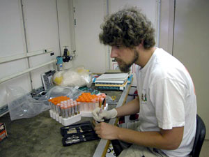 Scientist Mercer Brugler in the bio lab, labeling samples. With the number of specimens we're bringing in, classifying and labeling them is an essential part of the scientific process.