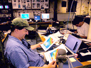 Co-chief scientists Jess Adkins and Dan Scheirer spend a lot of time marveling over, and rejoicing in, the quality of ABE maps, which help guide decisions about Alvin dives and other research. The two maps in Jess' hands use 10-meter contour lines, allowing for extremely precise navigation.