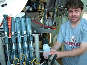 Scientist Jeff Mendez unloads water samples from Alvin at the end of the day. Most people tend to gather around the collection basket when the sub comes up to see what’s in it, but these bottles store important data regarding water chemistry at the dive site.