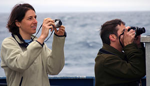  The paparazzi? No, these photographers are researchers Alison LaBonte and Mitch Elend on the deck capturing Alvin as it descended from the fantail. 
