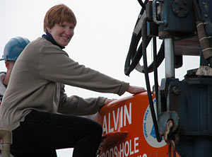 An exciting day for Graduate Student Brooke Love, who headed to the seafloor for the first time in Alvin. During seven hours in the sub with Chief Scientist Deb Kelley and Pilot Pat Hickey, they used Alvin to place new markers at the hydrothermal structures and collect old, faded markers. (Photo by Mitch Elend) 