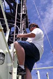Jeff Perkins climbs down from the “antenna farm,” the platform above the bridge on Atlantis that holds more than two-dozen antennae. Jeff maintains the ship’s radar, communications, and navigations systems. He is also the primary radio operator during distress situations.