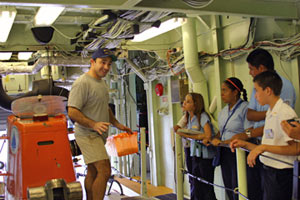 Alvin pilot Anthony Tarantino gives six students from two Costa Rican junior high schools a tour of the submersible Alvin, They also toured the ship during their visit the afternoon before our departure. Their two-hour visit was part of a marine life and technology program at their schools. 
