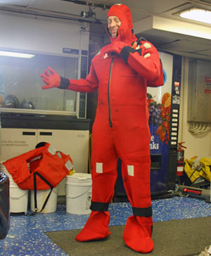 During a safety drill, WHOI guest Dan Dubno dons a �gumby suit, � named for the cartoon character. If we needed to jump in the water to evacuate the ship in an emergency, the suit would protect against cold water and provide flotation.