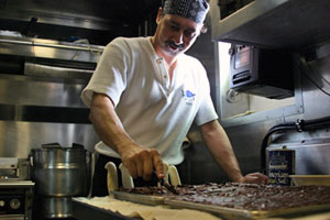 Cook Al Dalomba prepares macaroon brownies for an after dinner treat. Al hails from Wareham, Mass. and has cooked throughout the world for cruise lines and White House events. He’s one of two people responsible for feeding 53 people on this expedition.