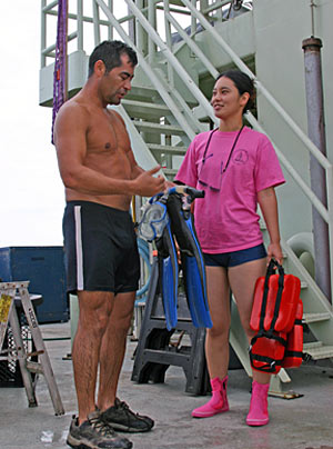 Shipboard technician Kazumi Baba asks Raul Martinez about his experiences as a swimmer certified to help launch and recover Alvin. Kazumi started her swim training today, a responsibility that requires good communication skills and strong swimming abilities. 