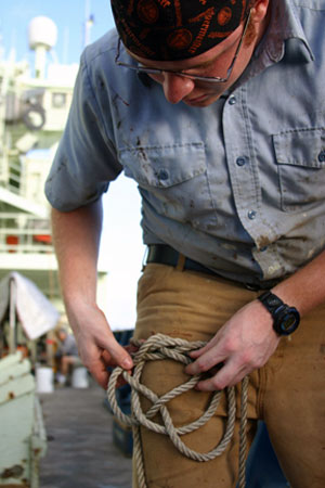 Seaman Mike Mulkern practices a masthead knot, used more for decorative purposes on masts or pole than for securing equipment on Atlantis. 