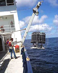 Scientists launch the CTD over the side then lower it to the seafloor in search of hydrothermal vent signals.