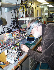 Al Bradley, one of ABE’s inventors, works on its computer brains.  