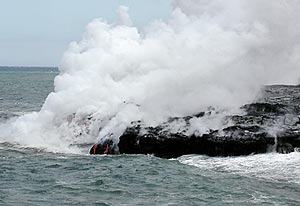  Ocean entry of the Pu’u Oo flow, Kilauea volcano Hawaii in June, 2001. Note the two small rivulets of lava cascading down the face of the flow just above the water line in the center-left of the frame. Distance across the photo is about 20 meters. 