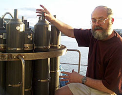 Bob Collier checks one of the water sampling bottles on the CTD frame.