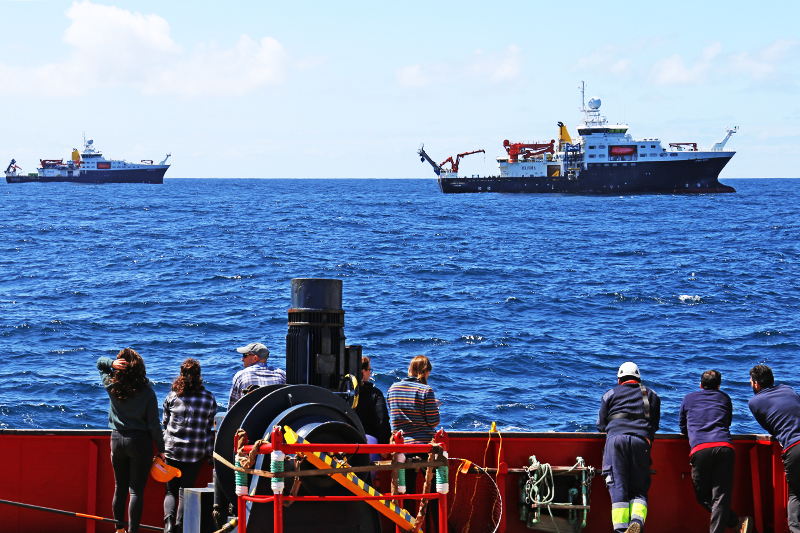 Members of the science team and crew aboard the Sarmiento de Gamboa gather to wave and take pictures of the RRS Discovery and the RRS James Cook during a coordinated rendezvous in the North Atlantic. Photo by Michelle Cusolito, @Woods Hole Oceanographic Institution