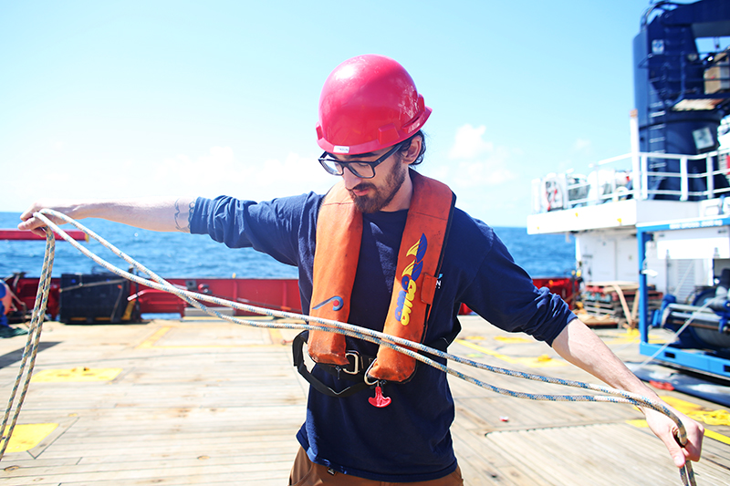 Jackson Sugar prepares a line to attach to a MINION. Photo by Marley Parker, @Woods Hole Oceanographic Institution